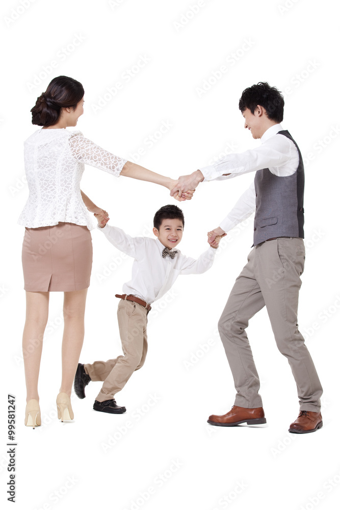 Happy young family spinning in circle, hand in hand