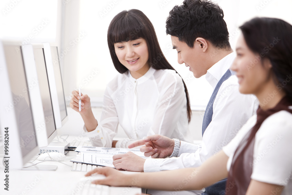 Cheerful white collar workers using computers in office Cheerful white collar workers using computers in office