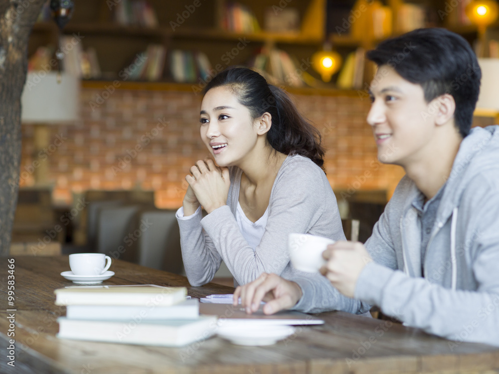 Young man and woman drinking coffee in cafe Young man and woman drinking coffee in cafe