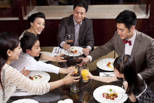 Foto Family having dinner in a luxurious dinning room