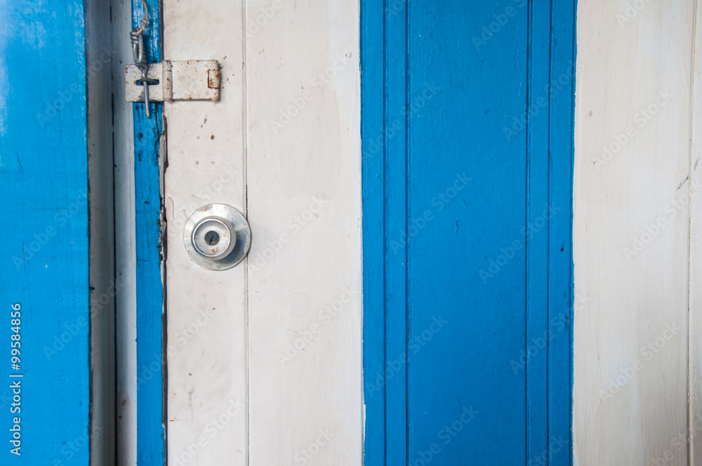 Stainless steel white and blue wood door knob and a key hole
