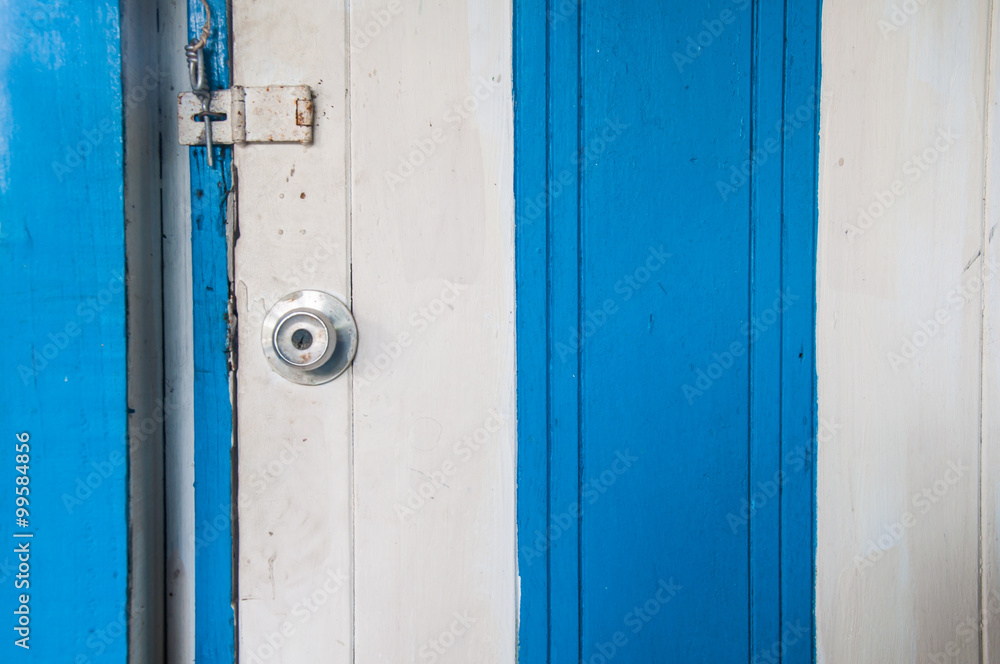 Stainless steel white and blue wood door knob and a key hole Stainless steel white and blue wood door knob and a key hole