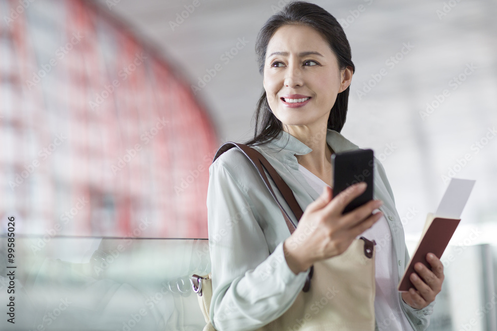 Mature woman waiting at airport Mature woman waiting at airport