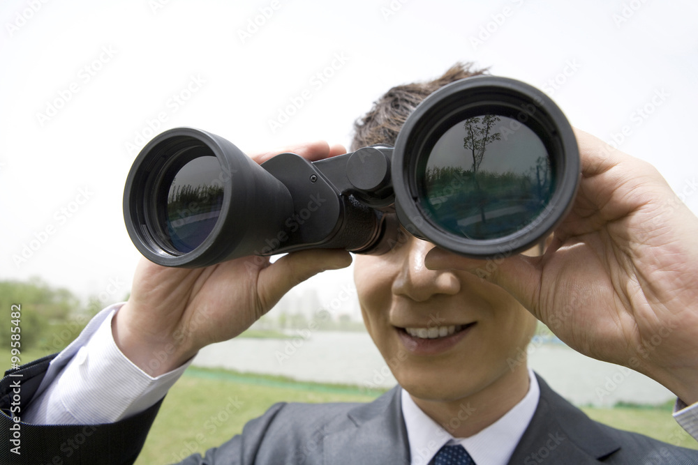 Businessman using binoculars Businessman using binoculars