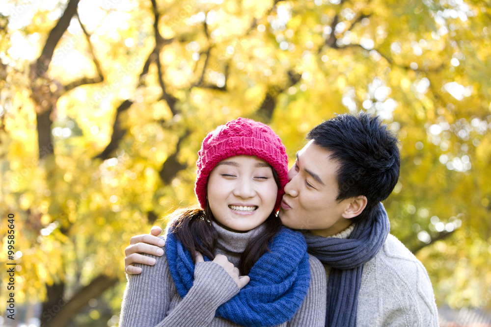 Young Couple Enjoying a Park in Autumn