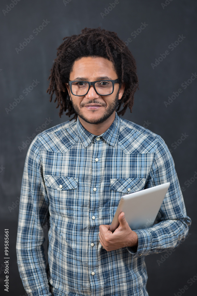 Enjoying his digital tablet. Cheerful young African man holding Enjoying his digital tablet. Cheerful young African man holding