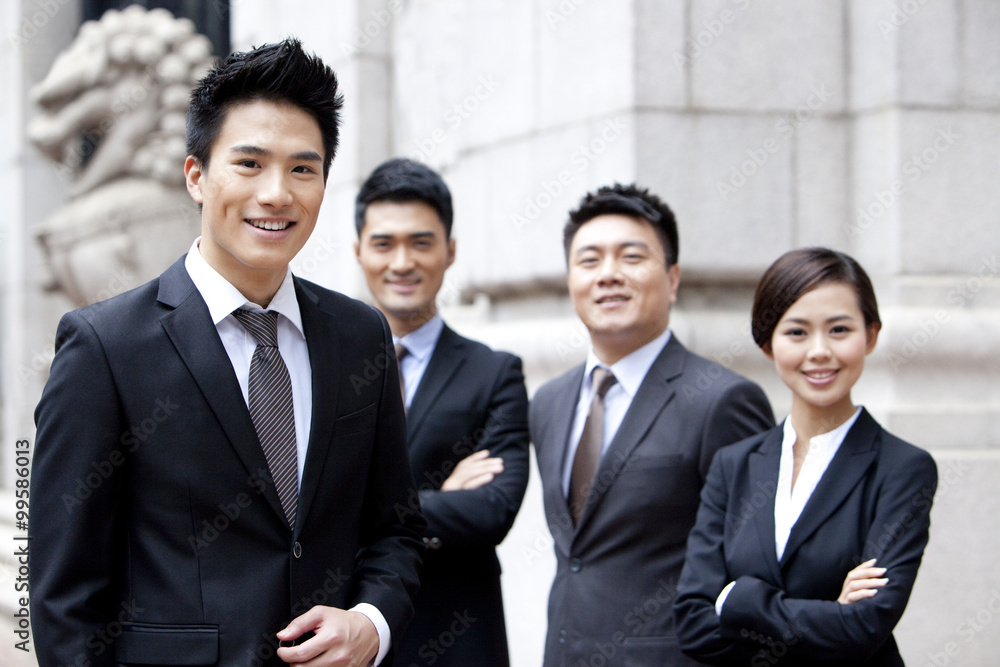 Portrait of confident business team outside a building, Hong Kong Portrait of confident business team outside a building, Hong Kong