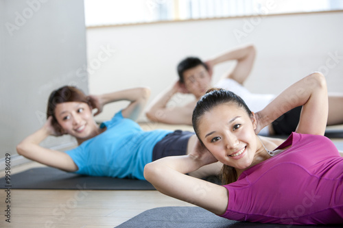 Young Woman Lying Down in Yoga Class