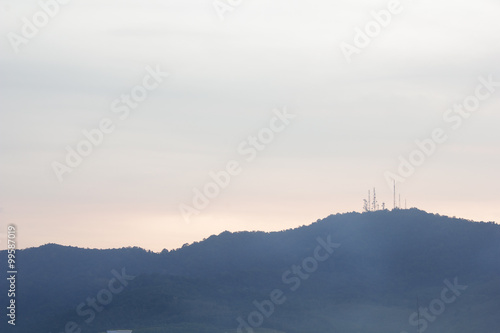 Landscape of cloudy sky and mountain which has signal tower on top in morning