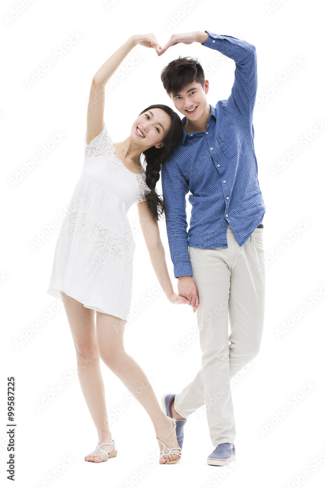 Young couple making heart shape with their arms Young couple making heart shape with their arms