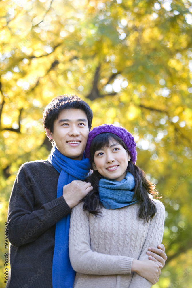 Young Couple Enjoying a Park in Autumn Young Couple Enjoying a Park in Autumn