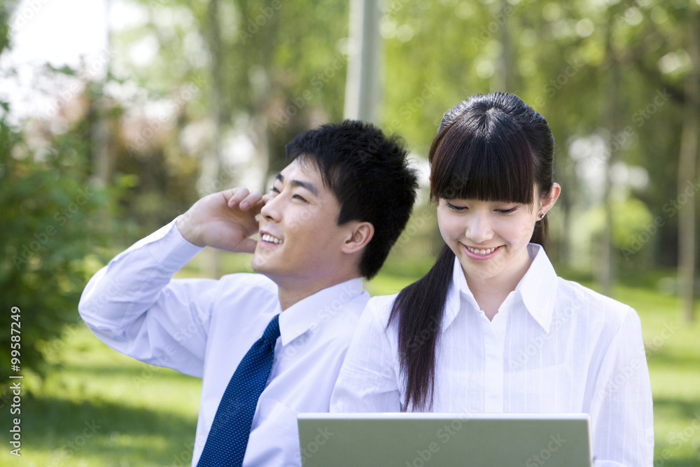 Man and woman on telephone in park