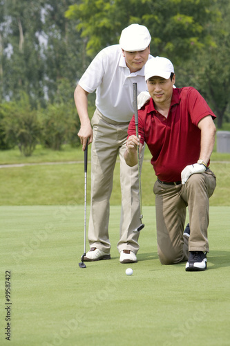 Two male Golfers on Green