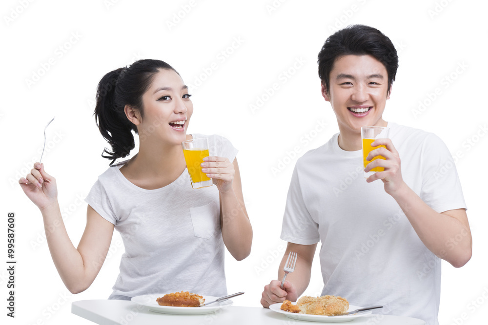 Cheerful young couple having breakfast Cheerful young couple having breakfast