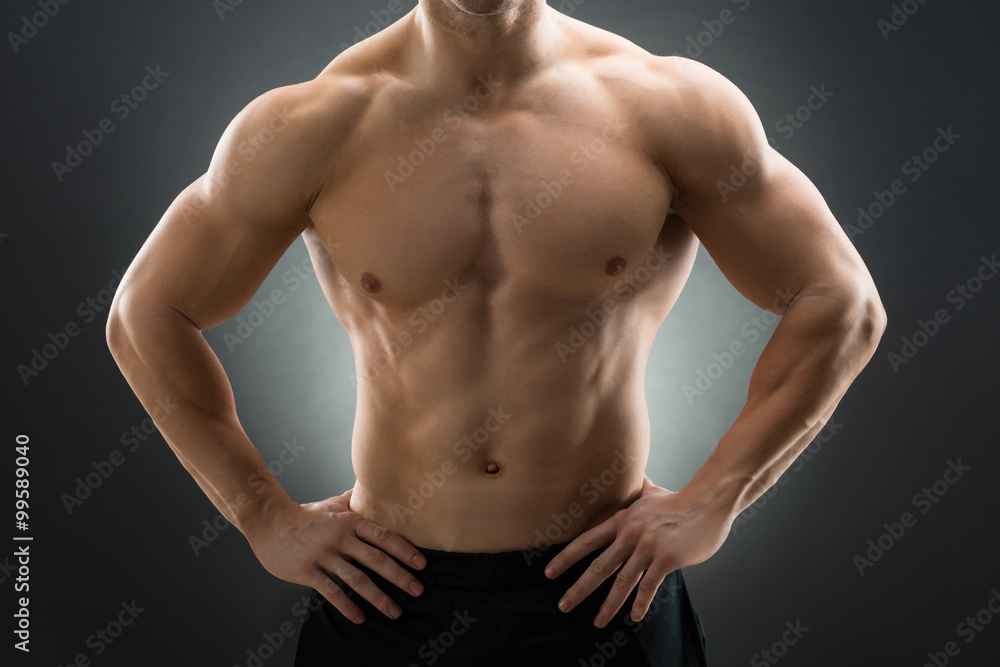 Muscular Man Standing With Hands On Hip Muscular Man Standing With Hands On Hip