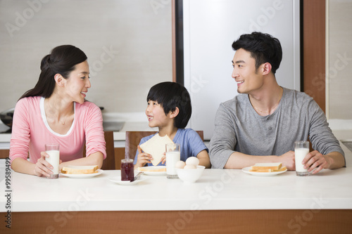 Happy family having breakfast