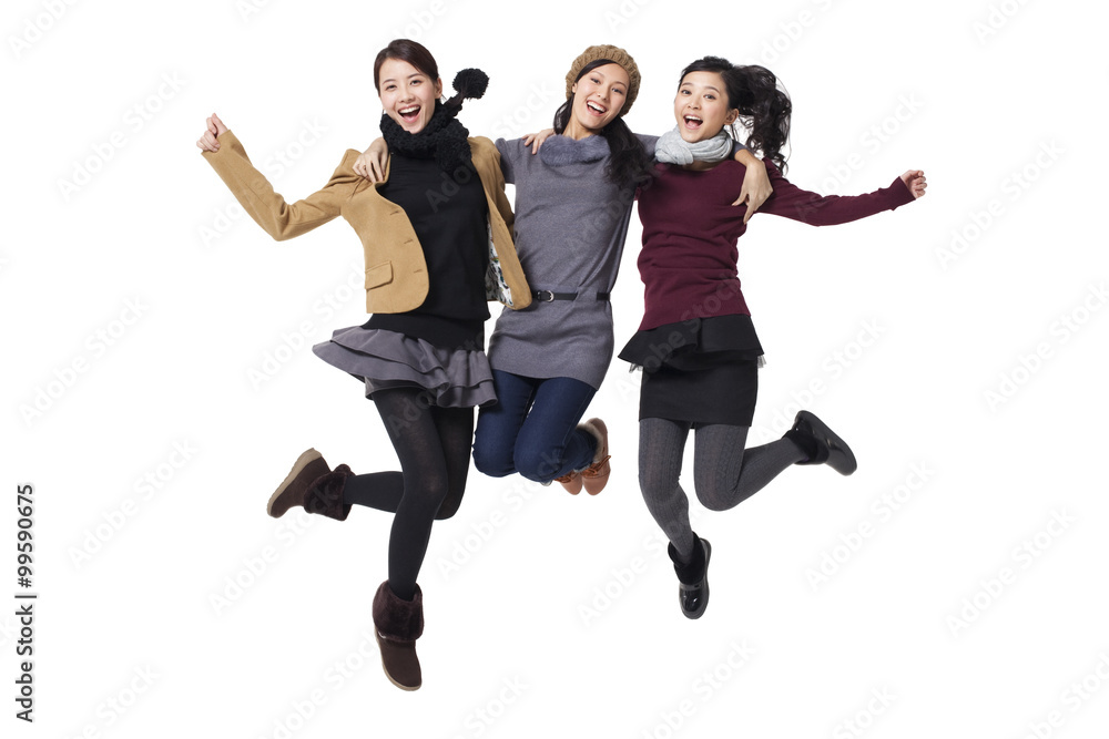 Young women jumping in mid-air