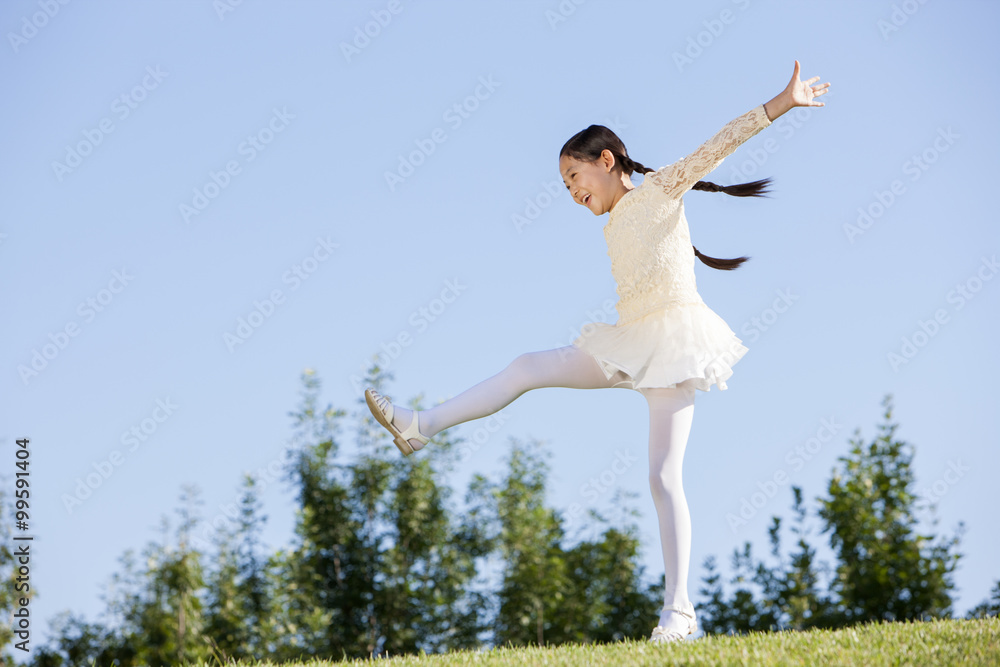 Excited young girl enjoying herself in a park Excited young girl enjoying herself in a park