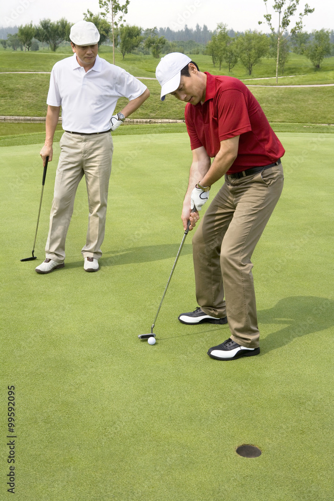 Fototapeta premium Two male Golfers on Green