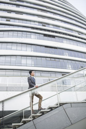 Businessman standing in front of office building