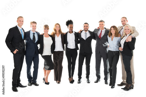 Confident Business Team Standing With Arms Around