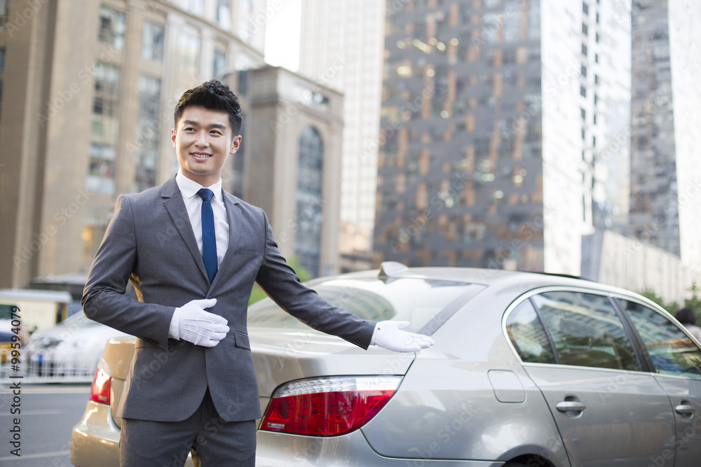 Chauffeur greeting next to the car Chauffeur greeting next to the car