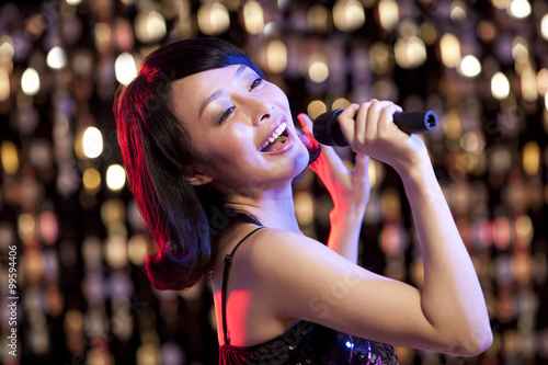 Young woman singing Karaoke