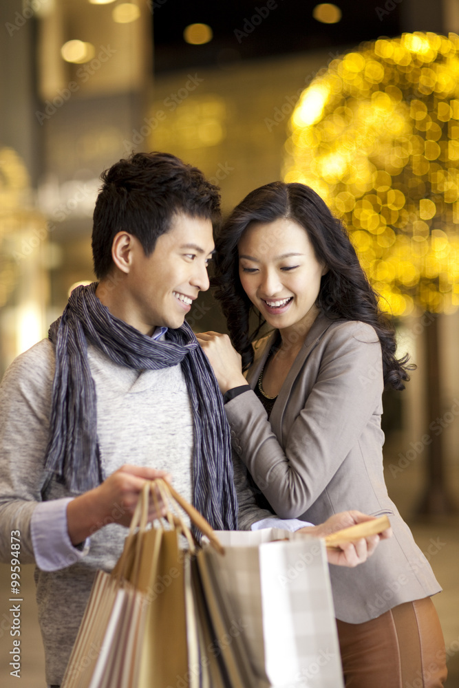 Young man giving a surprise to young woman Young man giving a surprise to young woman