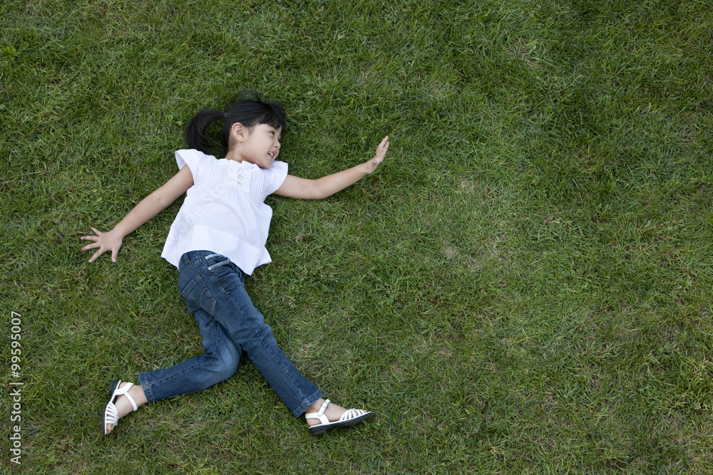 Chinese girl on the grass pretending to run