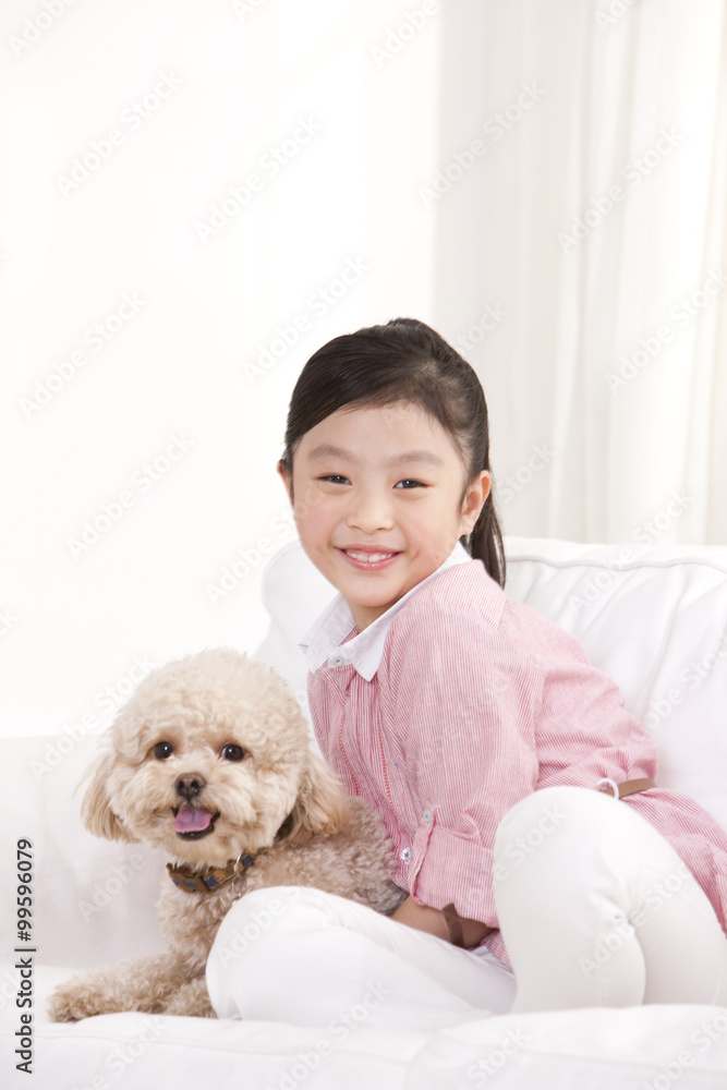 Little girl playing with a pet toy poodle Little girl playing with a pet toy poodle