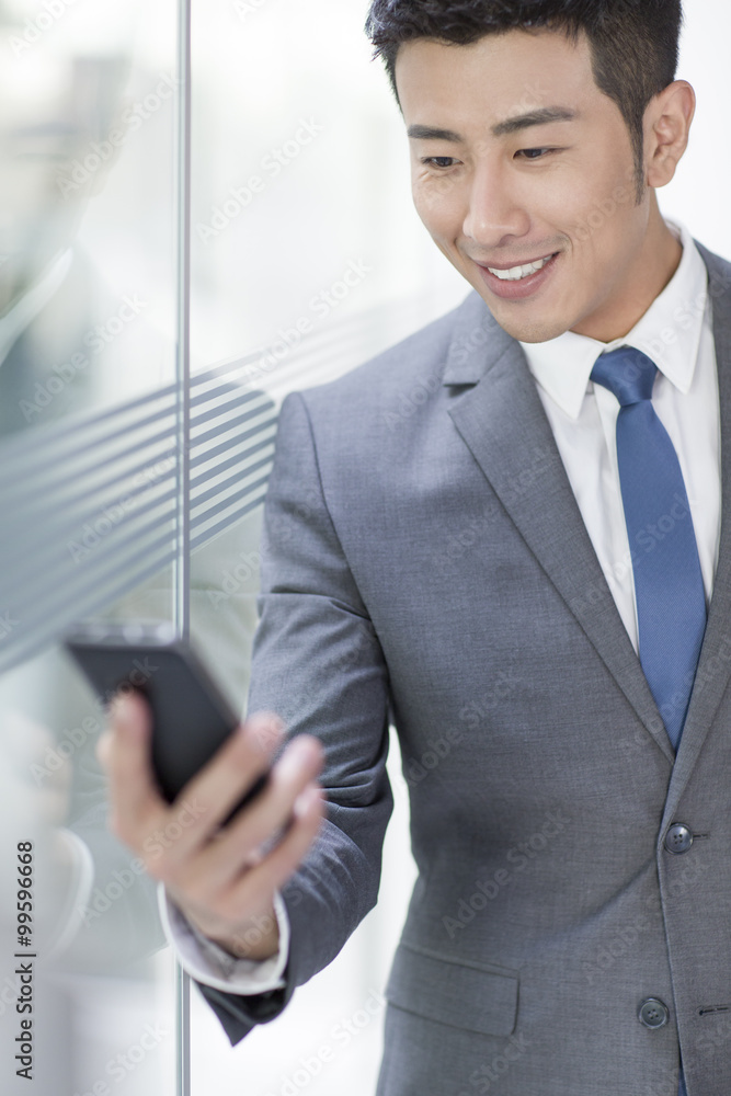 Young businessman using smart phone