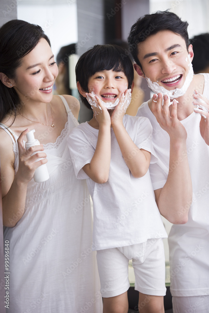 Family in bathroom with shaving cream on chin Family in bathroom with shaving cream on chin