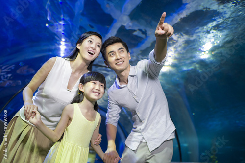 Young family in aquarium