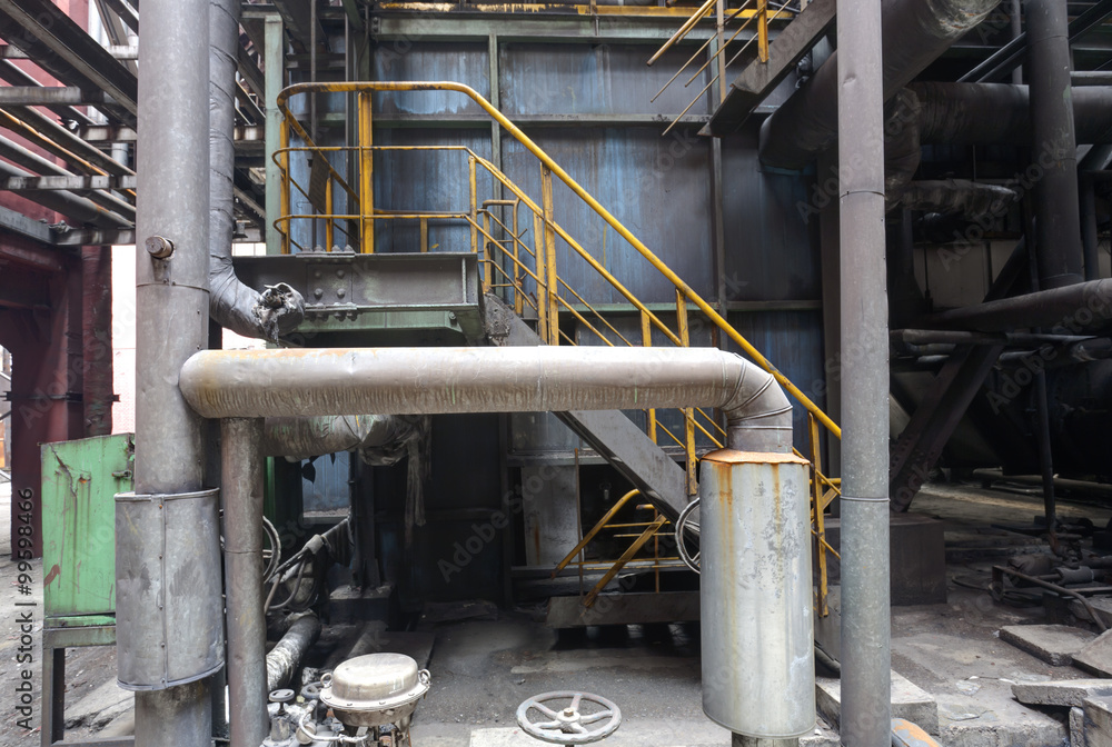 Fototapeta premium Interior of abandoned steel mill with pipes and valves.