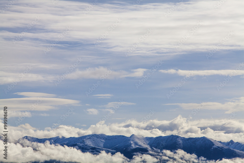 Snow mountains and cloudy sky in Tibet, China Snow mountains and cloudy sky in Tibet, China