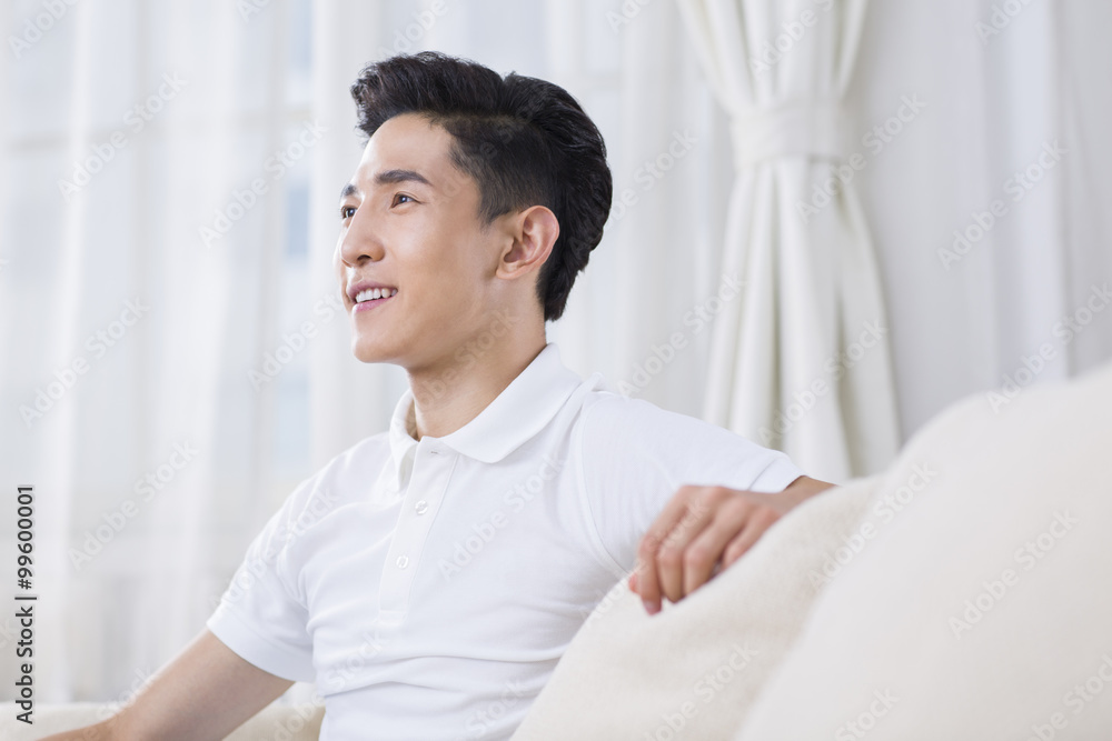Young man sitting on the sofa Young man sitting on the sofa