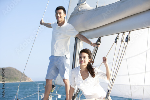 Happy young couple on a sailboat