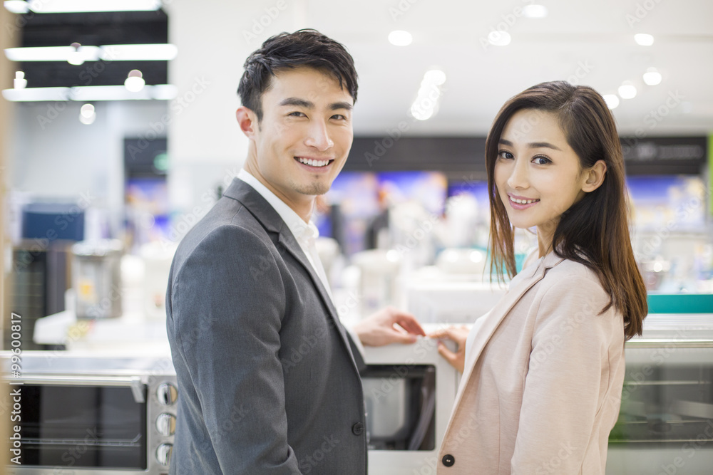 Young couple shopping in electronics store Young couple shopping in electronics store