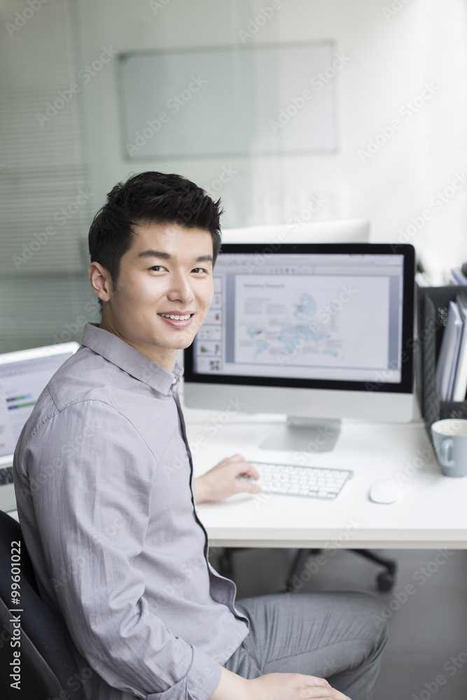 Young businessman using computer in office Young businessman using computer in office
