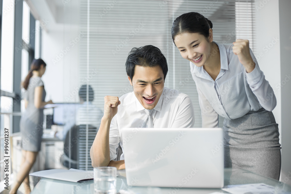 Young businesswoman and businessman talking in office Young businesswoman and businessman talking in office