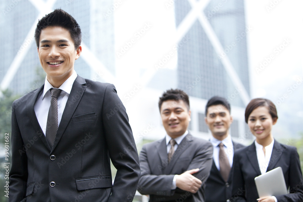 Cheerful businessman with his team in Hong Kong Cheerful businessman with his team in Hong Kong