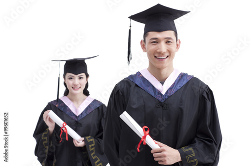 Happy college graduates in graduation gowns photo