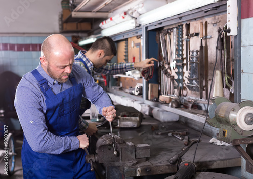 Professional mechanics in repair shop © JackF