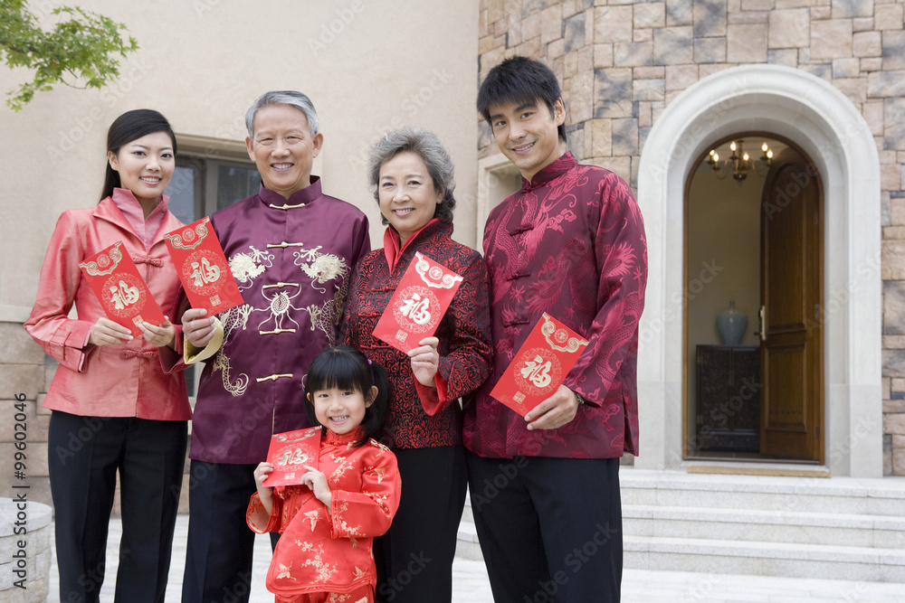 Three generation family holding Chinese new year red envelope Three generation family holding Chinese new year red envelope