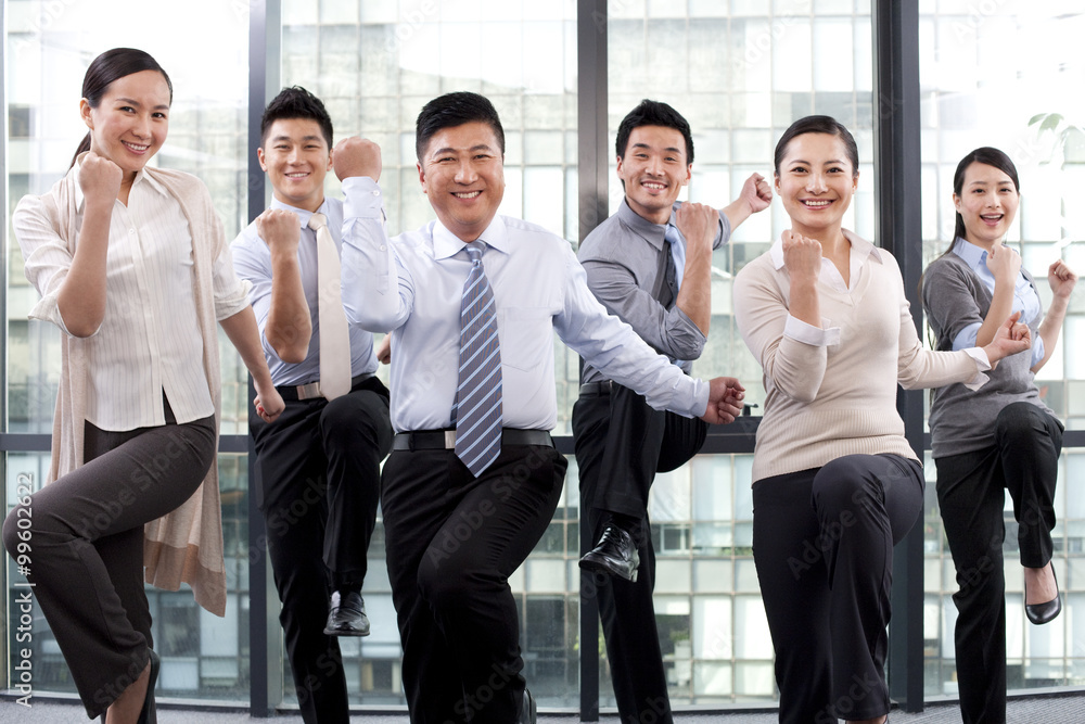 Excited businesspeople posing with fists raised Excited businesspeople posing with fists raised