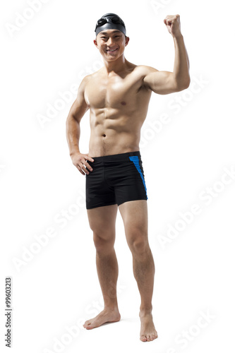 Muscular swimmer raising his fist