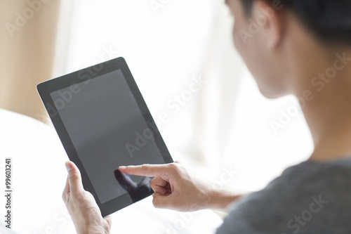 Young man using digital tablet