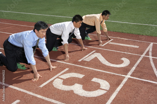 Businessmen Lined Up On A Race Track