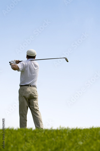 Golfer swinging club