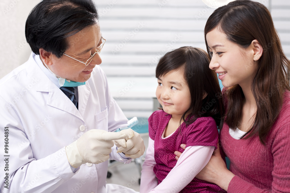 Dentist teaching the right way of brushing teeth Dentist teaching the right way of brushing teeth